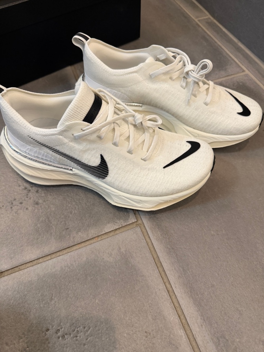 Nike White Athletic Sneakers with Black Swoosh Accents